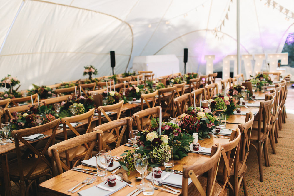 Wooden Tables Cross Back Chairs Greenery Flowers Stretch Tent Floral Farm Wedding Jessica O'Shaughnessy Photography