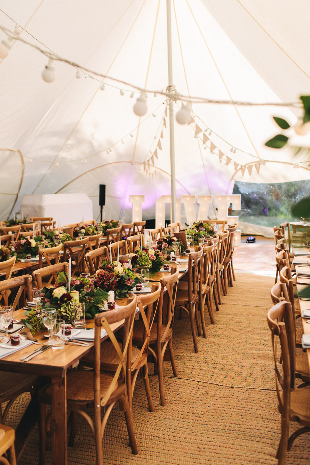 Stretch Tent Bunting Festoon Lighting Wooden Tables Cross Back Chairs Greenery Flowers Floral Farm Wedding Jessica O'Shaughnessy Photography