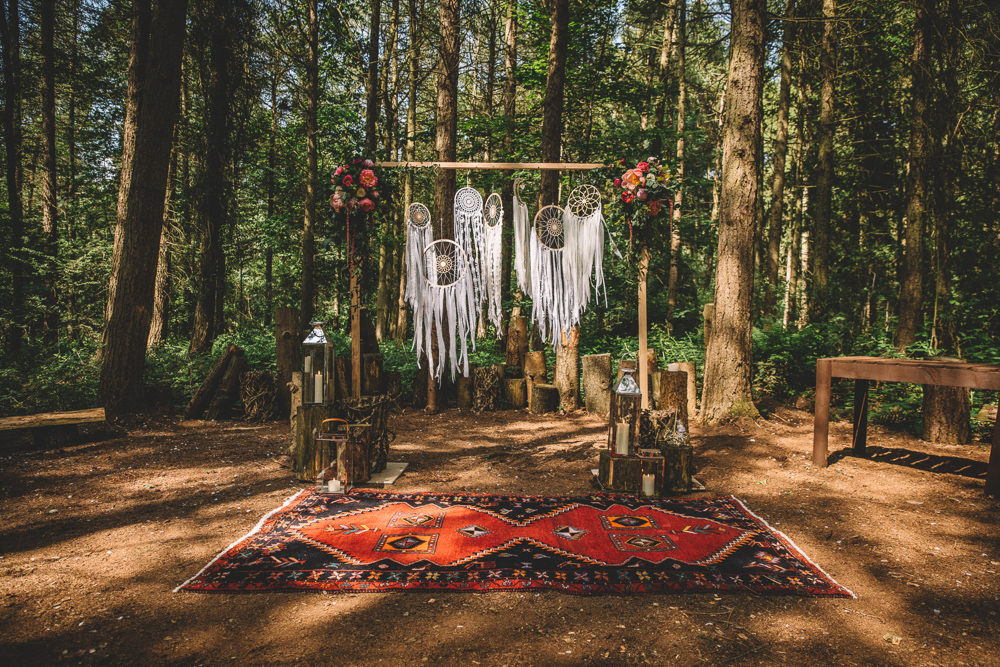 Ceremony Backdrop Wooden Frame Log Stumps Candles Persian Rug Aisle Dreamcatchers Flowers Bohemian Boho Free Spirited Wedding Ideas Woodland Lumiere Photographic