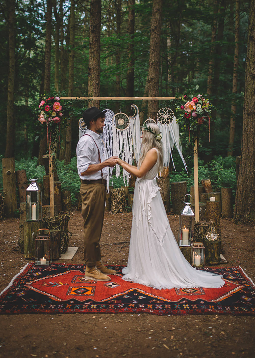 Ceremony Backdrop Wooden Frame Log Stumps Candles Persian Rug Aisle Dreamcatchers Flowers Bohemian Boho Free Spirited Wedding Ideas Woodland Lumiere Photographic