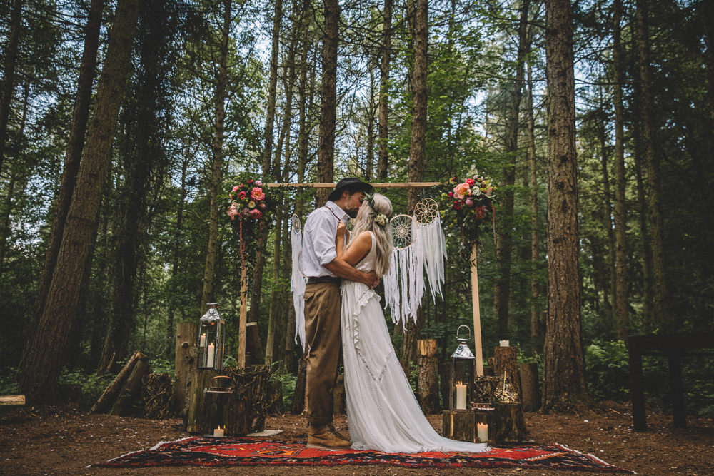 Ceremony Backdrop Wooden Frame Log Stumps Candles Persian Rug Aisle Dreamcatchers Flowers Bohemian Boho Free Spirited Wedding Ideas Woodland Lumiere Photographic