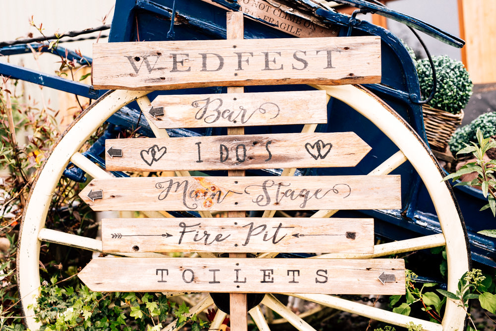 Wooden Direction Sign Rustic Wheel Wedfest Fun Quirky Colourful Wedding Fairclough Studios