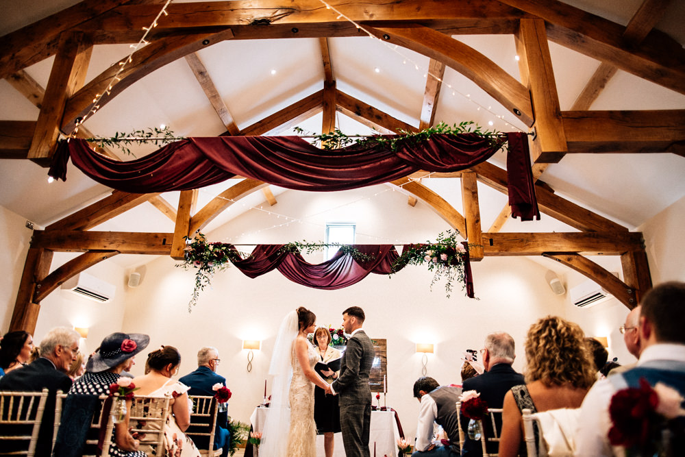 Burgundy Red Drapes Ceiling Fabric Fairy Lights Aisle Chair Flowers Ribbons Ceremony Gamekeepers Inn Wedding Fairclough Studios