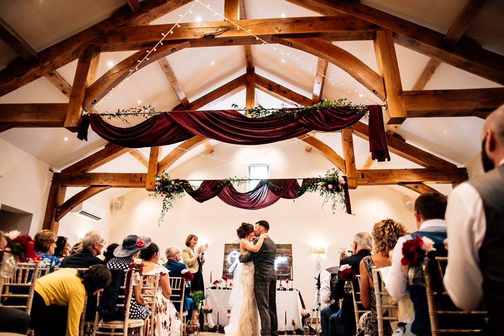 Burgundy Red Drapes Ceiling Fabric Fairy Lights Aisle Chair Flowers Ribbons Ceremony Gamekeepers Inn Wedding Fairclough Studios