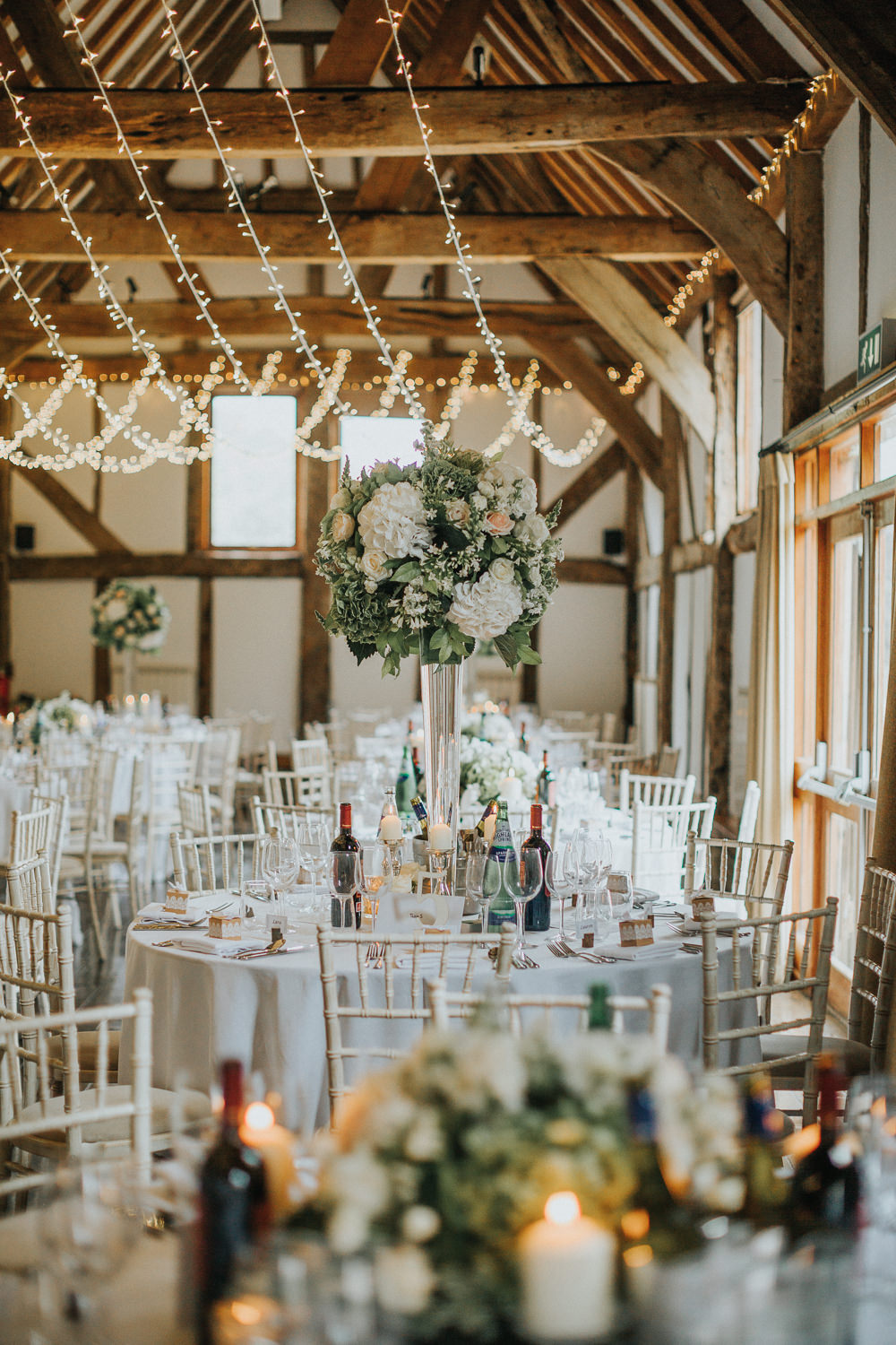 Tall table Centre Greenery White Peach Blush Roses Fairy Light Canopy Loseley Park Wedding Kit Myers Photography