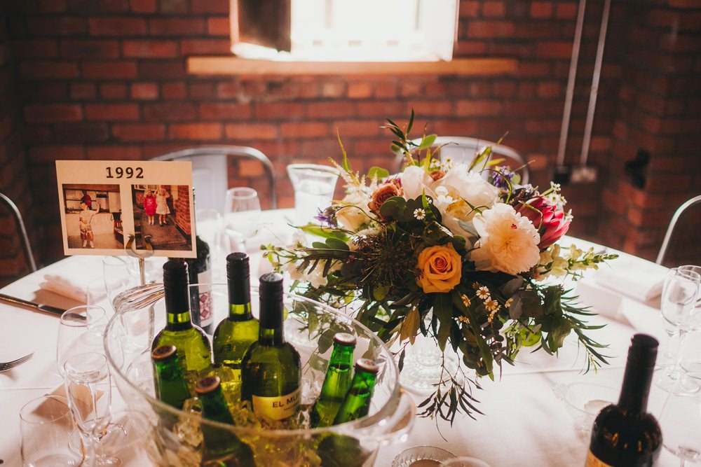 Table Flowers Centrepiece Blush Orange Foliage Greenery Rose Thistle Peony Victoria Warehouse Wedding Manchester Kate McCarthy Photography