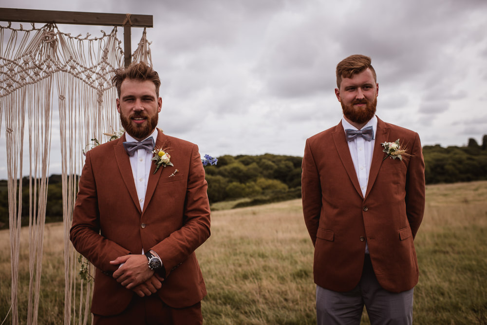 Tan Suit Groom Groomsman Bow Tie Macrame Ceremony Backdrop Wilkswood Farm Wedding Robin Goodlad Photography
