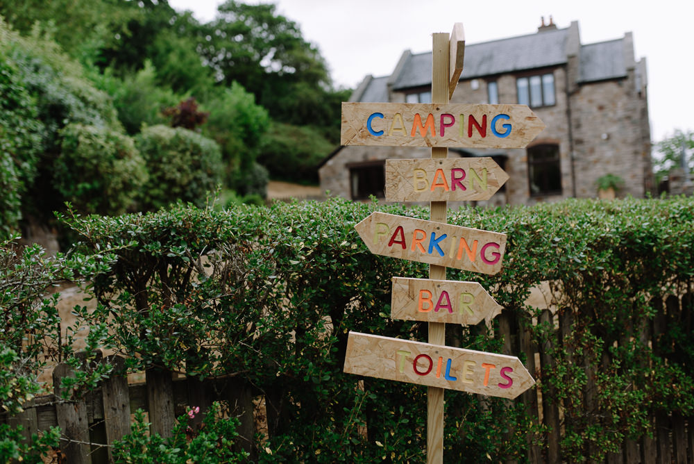 Painted Sign Signpost Boho Festival Wedding Matt Bowen Photography