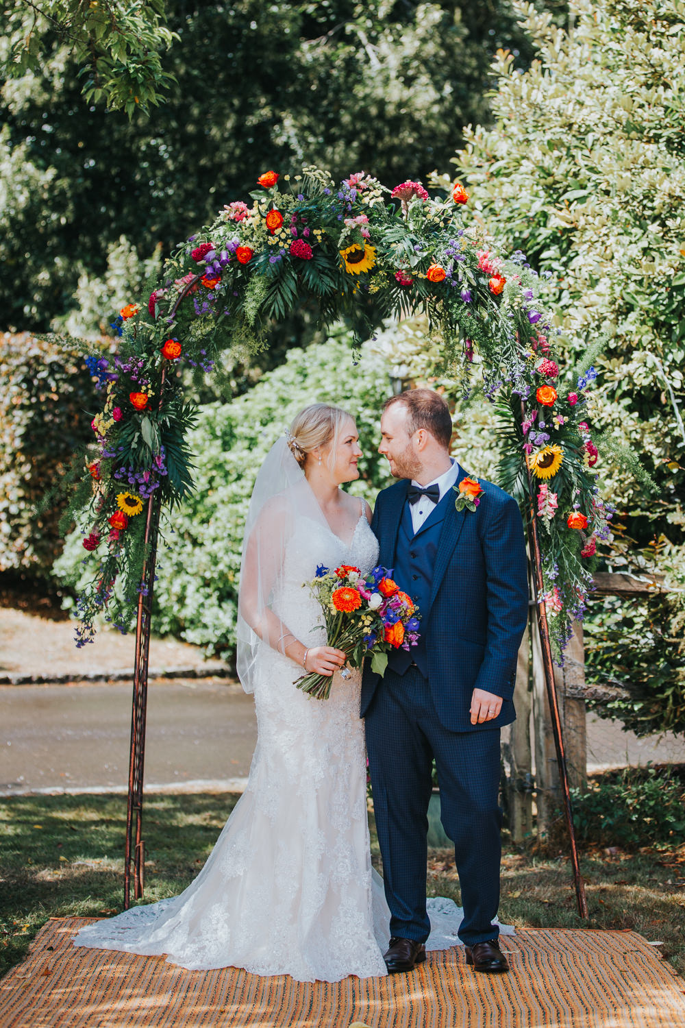 Flower Arch Backdrop Greenery Foliage Flowers Sunflowers Rose Colourful Tipi Wedding Charlotte Razzell Photography