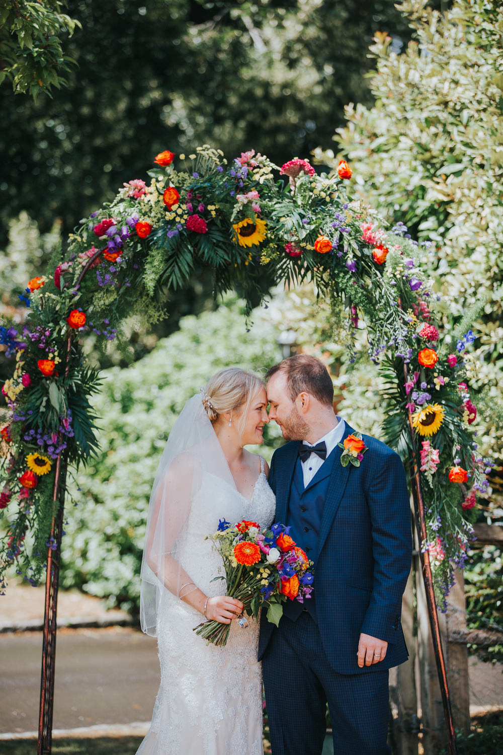 Flower Arch Backdrop Greenery Foliage Flowers Sunflowers Rose Colourful Tipi Wedding Charlotte Razzell Photography