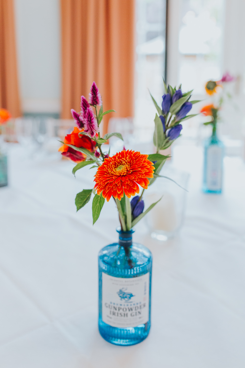 Gin Bottle Flowers Sunflower Decor Tables Colourful Tipi Wedding Charlotte Razzell Photography