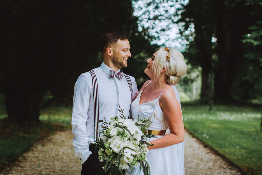 Bride Bridal Dress Strappy Gold Belt Bow Tie Braces Groom White Stocks Roses Bouquet Drenagh House Estate Wedding Monochrome Honey and the Moon Photography