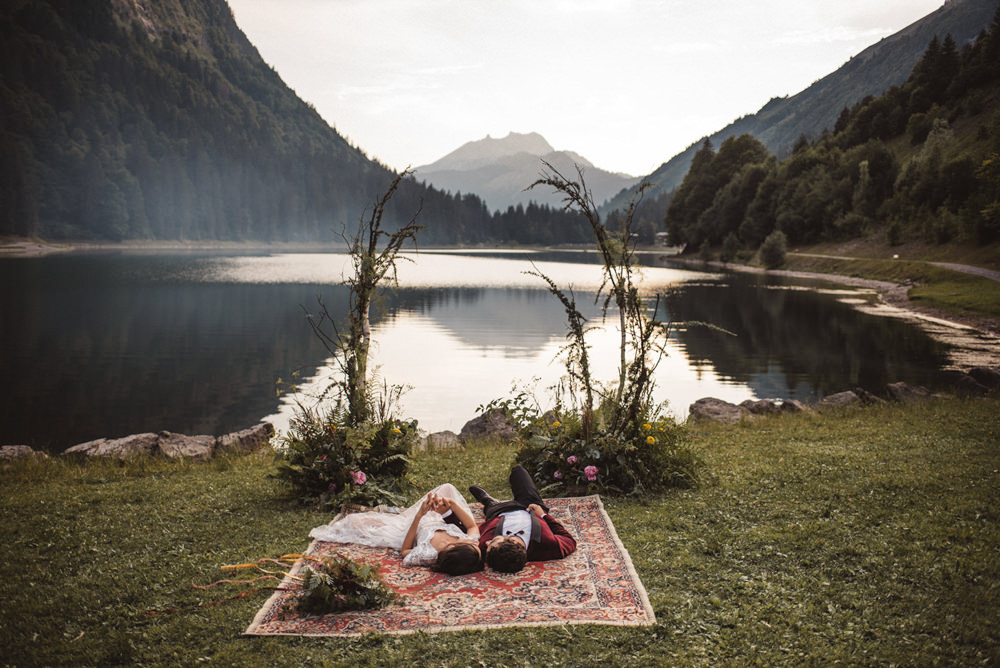Backdrop Flowers Ceremony Persian Rug Aisle Branches Lake Outdoor French Alps Folk Boho Mountain Wedding Ideas Katja & Simon Photography