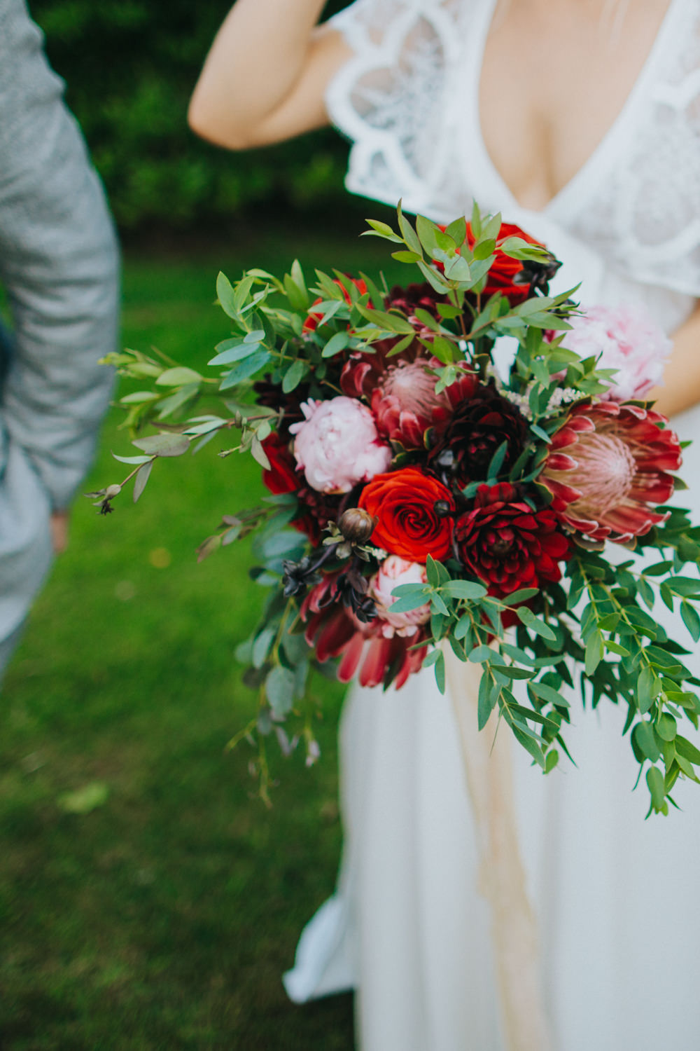 Bouquet Flowers Bride Bridal Red Greenery Foliage Ribbons Peony Peonies Rose Proteas Pink Godwick Great Barn Wedding Joshua Patrick Photography