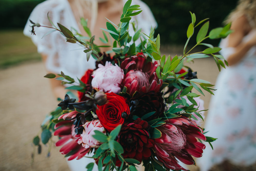 Bouquet Flowers Bride Bridal Red Greenery Foliage Ribbons Peony Peonies Rose Proteas Pink Godwick Great Barn Wedding Joshua Patrick Photography