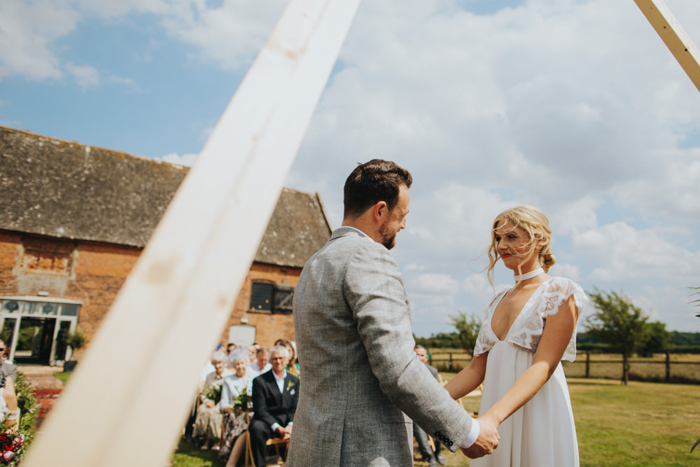 Aisle Ceremony Outdoor Persian Rug Wooden Triangle Backdrop Palm Plants Godwick Great Barn Wedding Joshua Patrick Photography