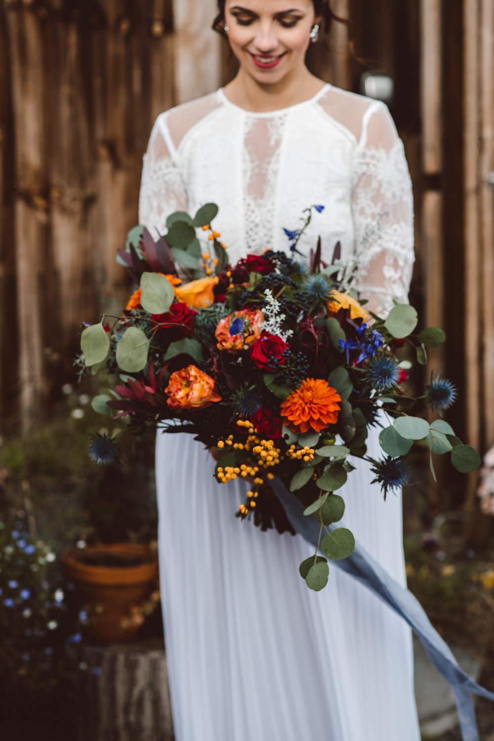Bouquet Flowers Bride Bridal Blue Delphiniums Thistles Grey Eucalyptus Orange Roses Dahlias Red Amaranthus Ribbons Rustic Christmas Wedding Ideas Dhw Photography