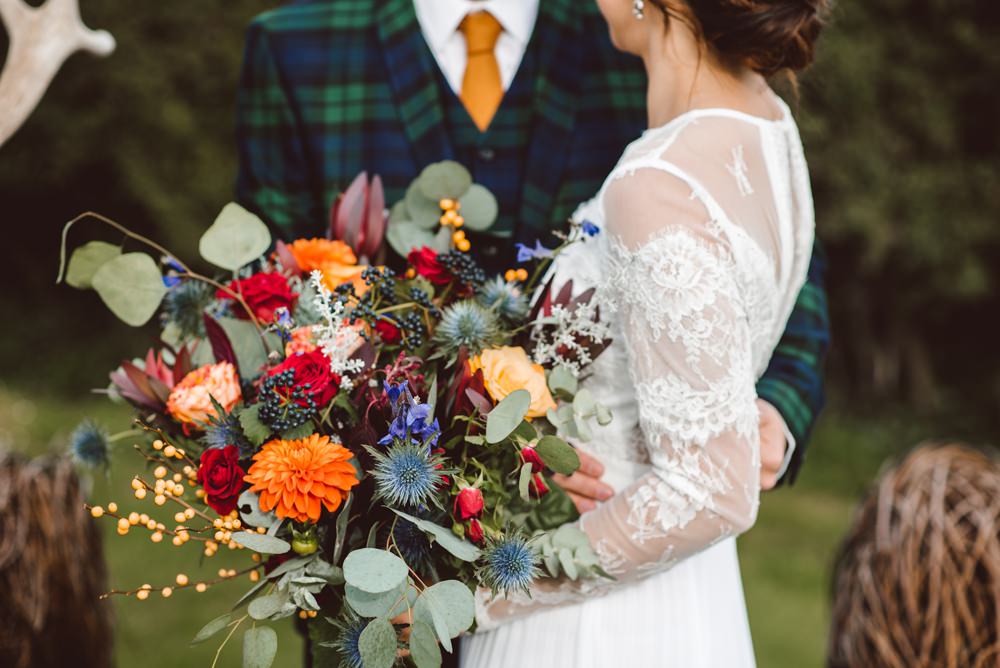 Bouquet Flowers Bride Bridal Blue Delphiniums Thistles Grey Eucalyptus Orange Roses Dahlias Red Amaranthus Ribbons Rustic Christmas Wedding Ideas Dhw Photography