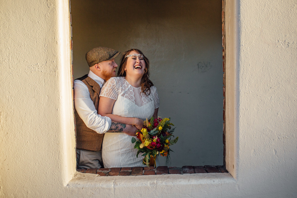 Bride Bridal High Neck Short Sleeve Lace Dress Crystal Headband Headpiece Sweetheart Neckline Waistcoat Tweed Chinos Flat Cap Multicoloured Bouquet Ribbon The Chimney House Wedding Ellie Grace Photography