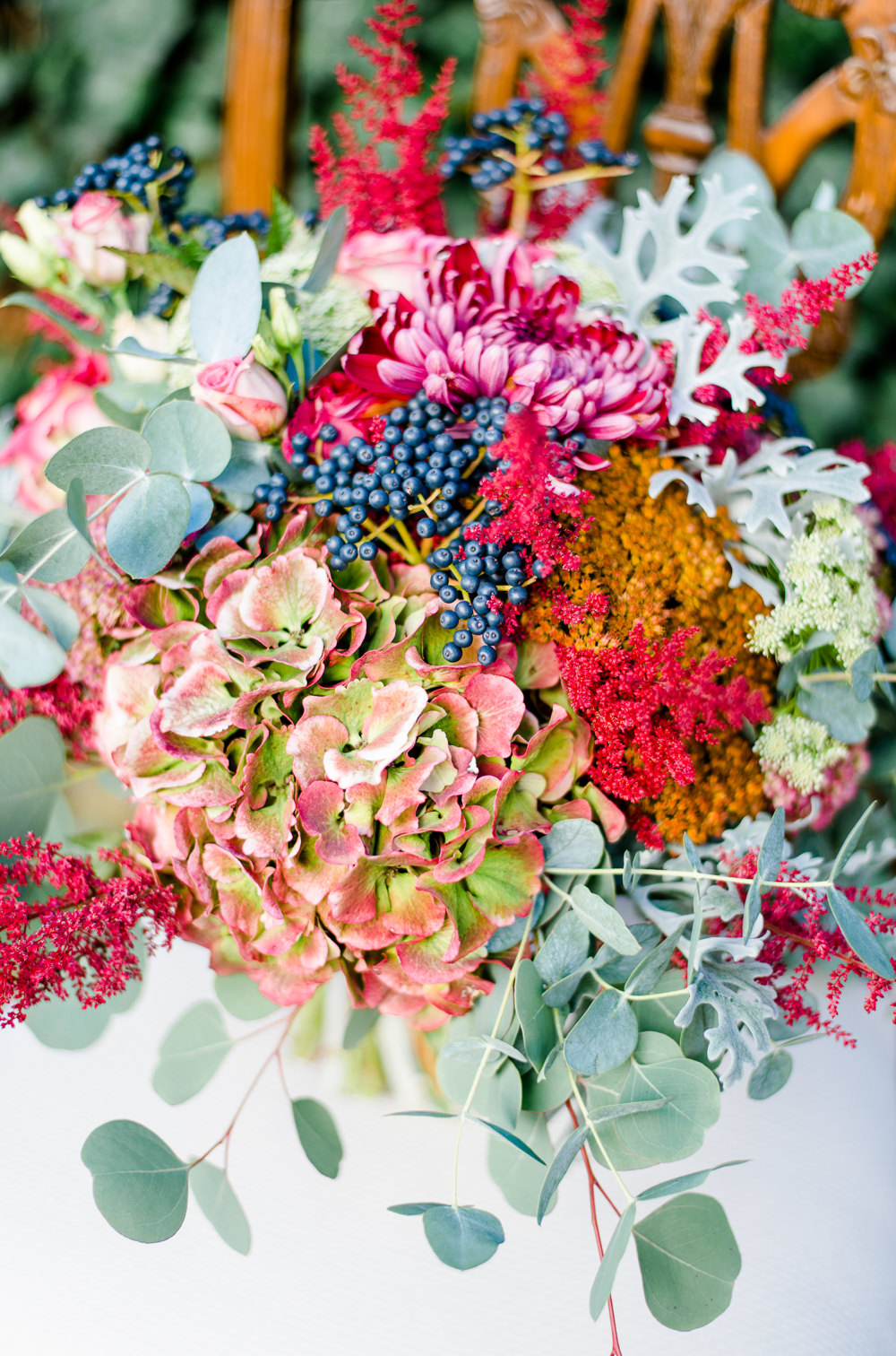 Bouquet Flowers Bride Bridal Red ORange Greenery Foliage Autumn Berries Hydrangea Eucalyptus Astilbe Autumnal Fairytale Wedding Ideas Miriam Peuser Photography