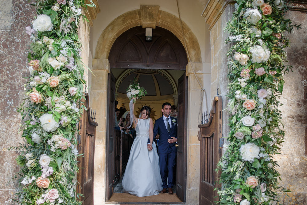 Bride Bridal A Line Dress Straps Sleeveless Silk Boat Neck Neck Blue Suit Groom Veil Flowers Floral Entrance Babington House Wedding Ria Mishaal Photography