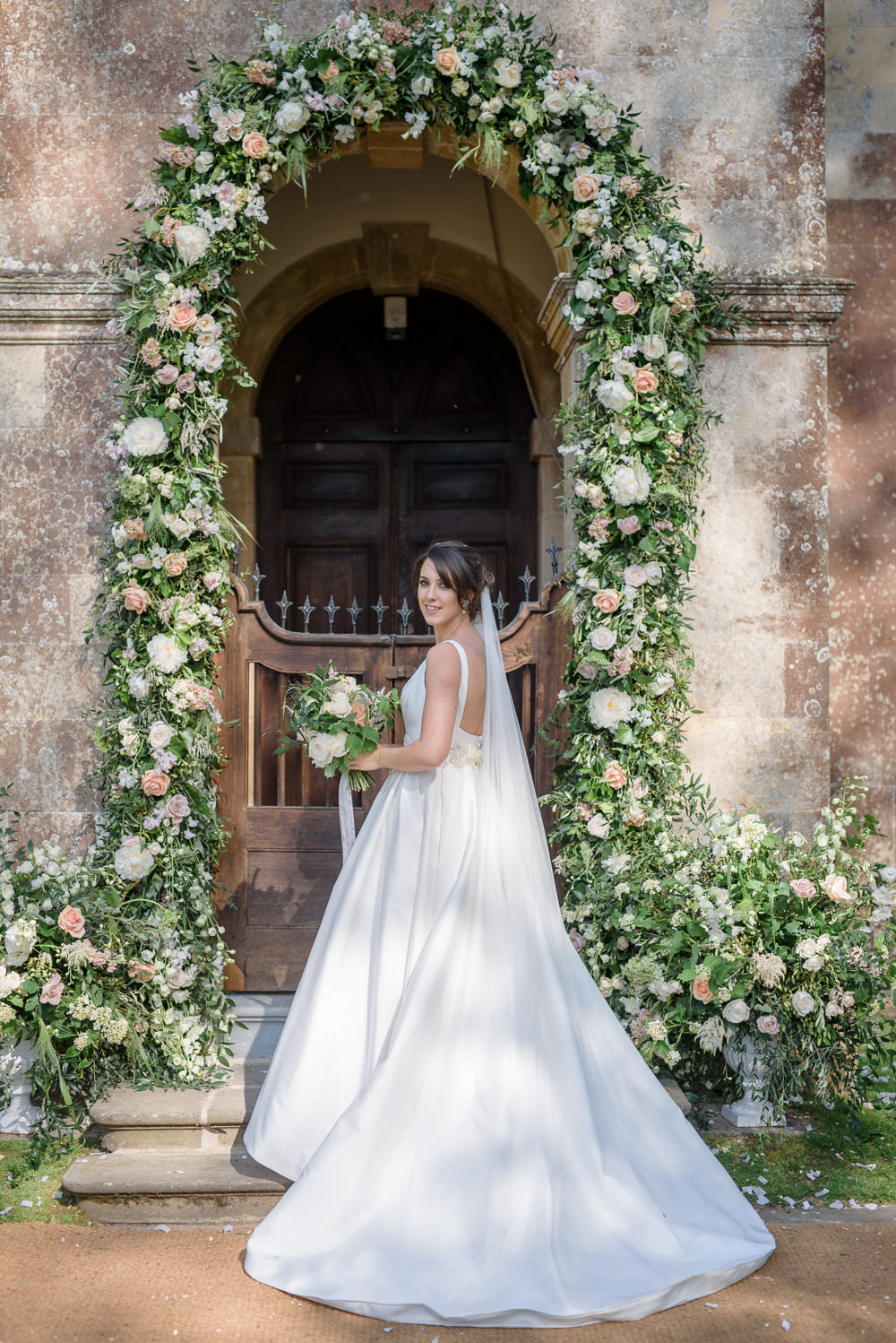 Bride Bridal A Line Dress Straps Sleeveless Silk Boat Neck Veil Entrance Archway Floral Flowers Bouquet Silk Ribbon Babington House Wedding Ria Mishaal Photography