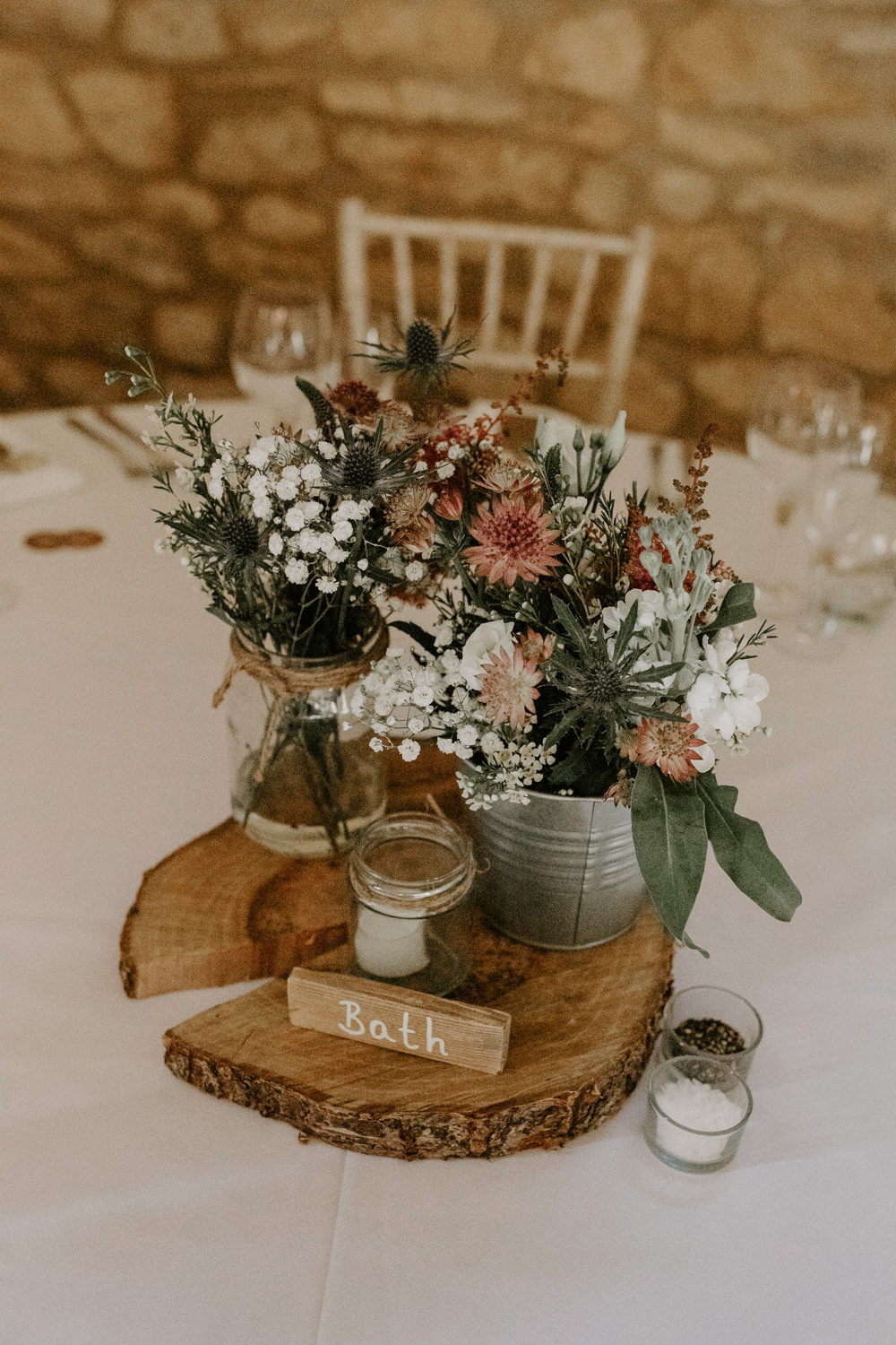 Flowers Watering Can Pink Grenery Thisle Astilbe Centerepice Log Rustic Table Barn Upcote Wedding Siobhan Beales Photography