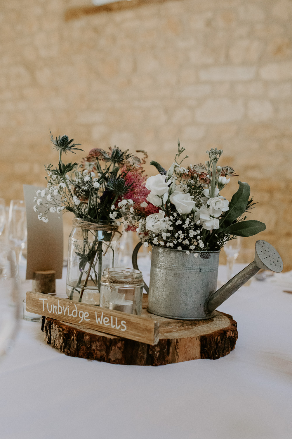 Flowers Watering Can Pink Grenery Thisle Astilbe Centerepice Log Rustic Table Barn Upcote Wedding Siobhan Beales Photography