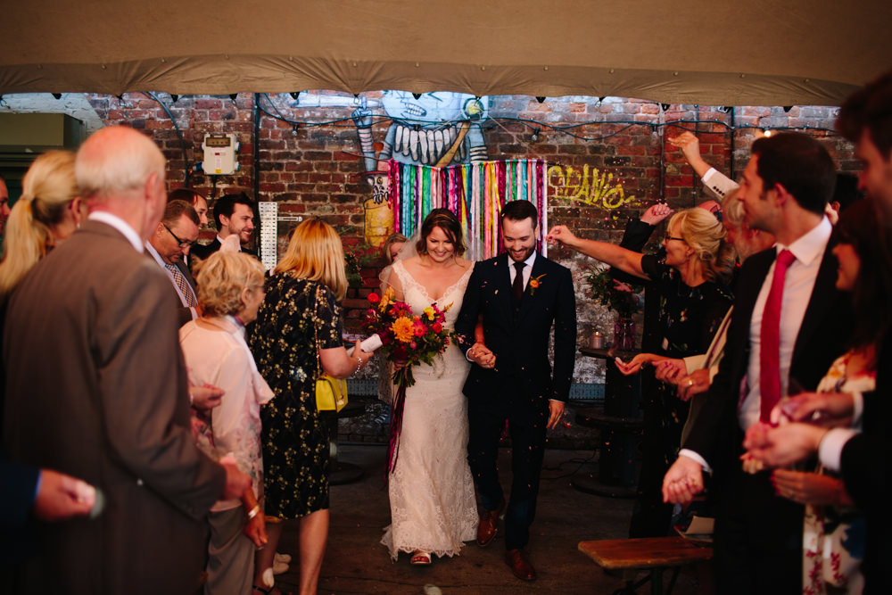 Bride Bridal Watters Lace Sleeveless Dress Gown Navy Suit Groom Colourful Multicoloured Bouquet Ribbon Backdrop Constellations Liverpool Wedding Dan Hough Photo