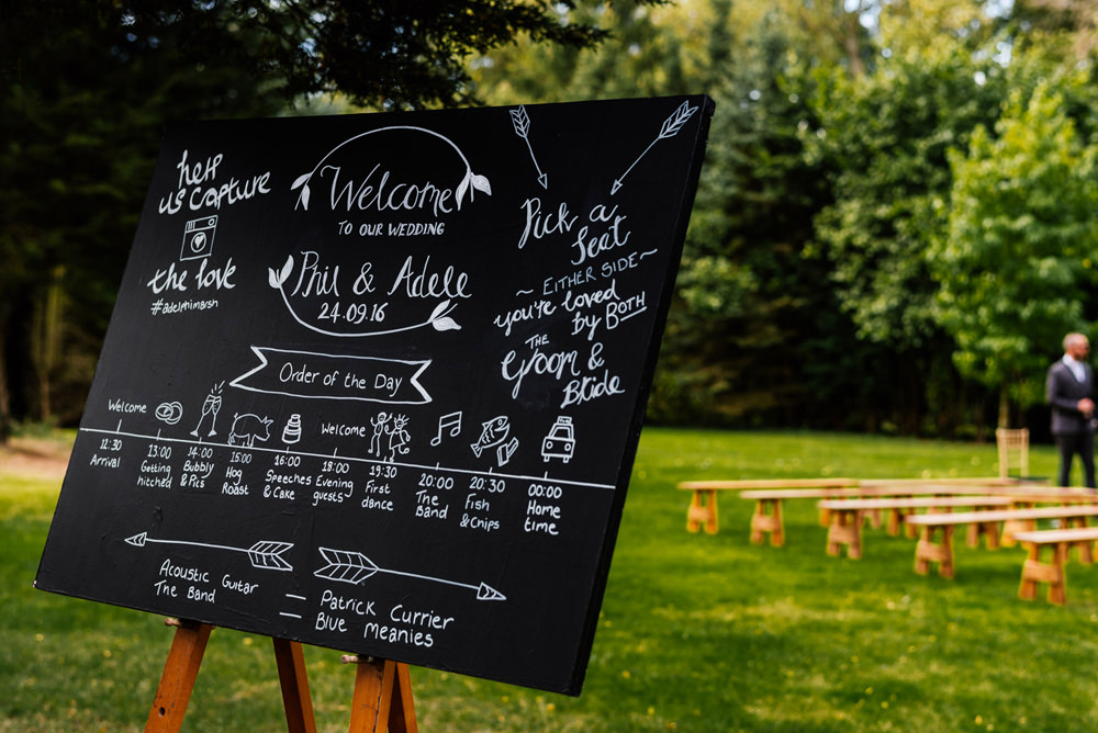 Order of the Day Blackboard Chalk Board Easel Outdoor Ceremony Secret Garden Wymington Wedding Aaron Collett Photography