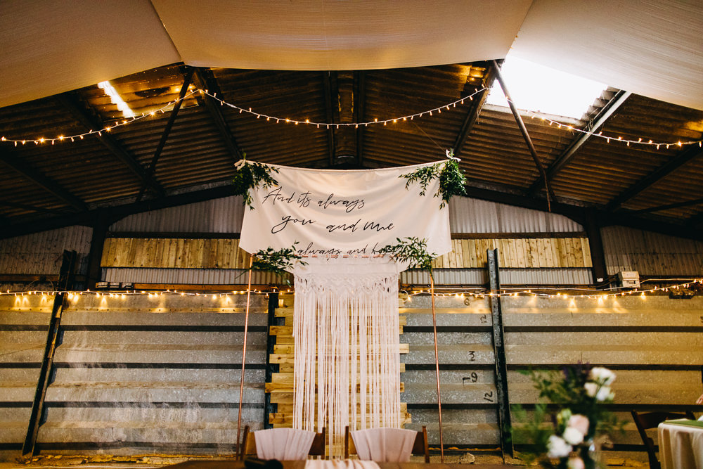 Ceremony Aisle Backdrop Barn Bohemian Macrame Banner Fabric Sign Fairy Lights Greenery Quote Bawdon Lodge Farm Wedding Hannah Hall Photography