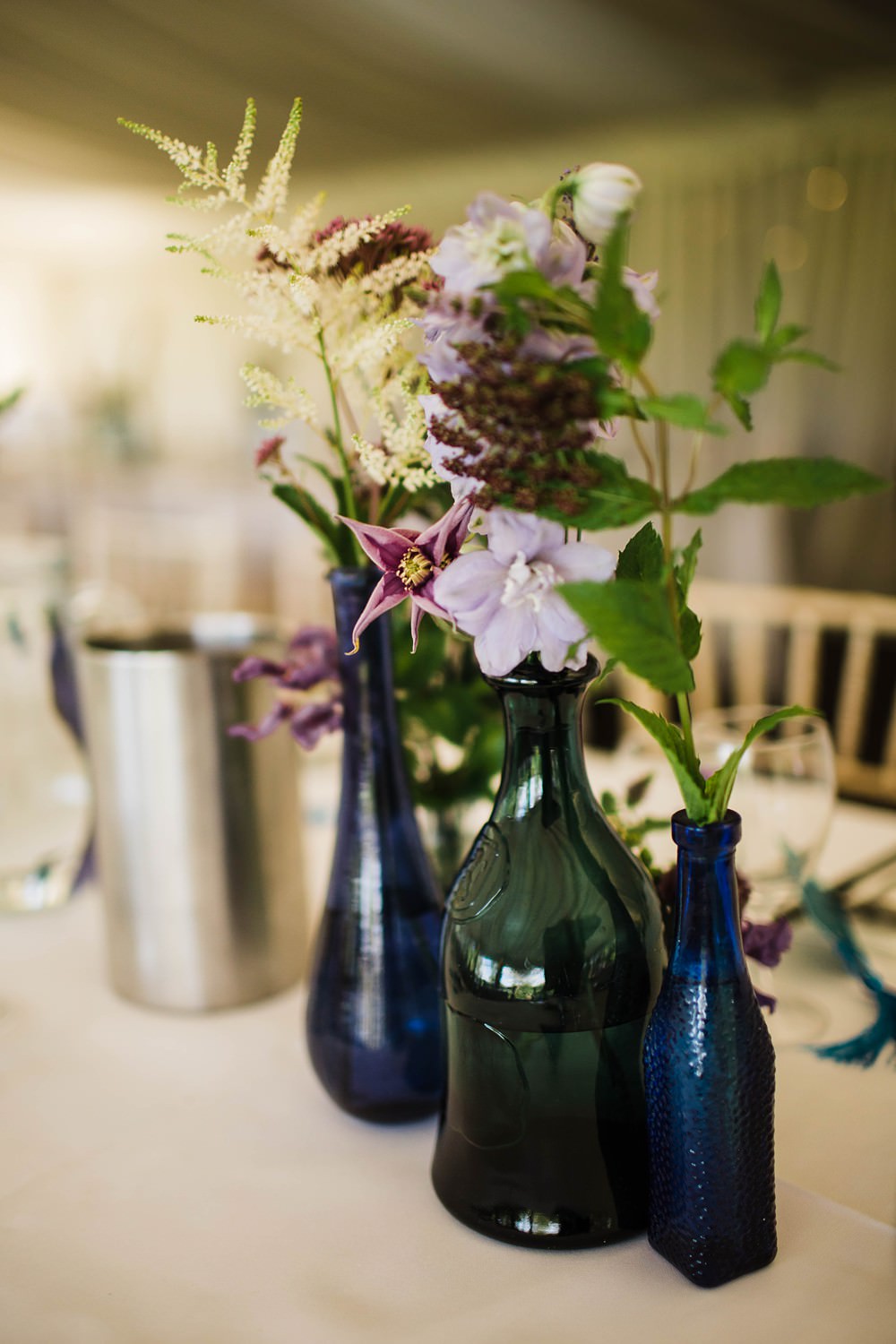 Bottles Flowers Blue Purple Cherwell Boathouse Wedding Claudia Rose Carter Photography