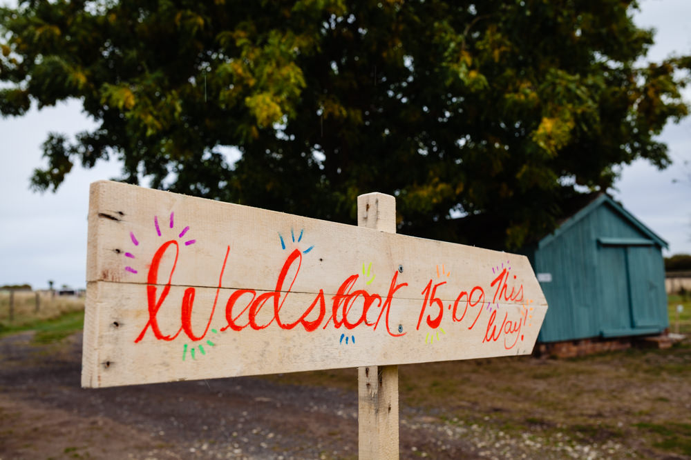 Wooden Rustic Sign Post Signage Colourful Festival Party Wedding Emma and Rich Photography
