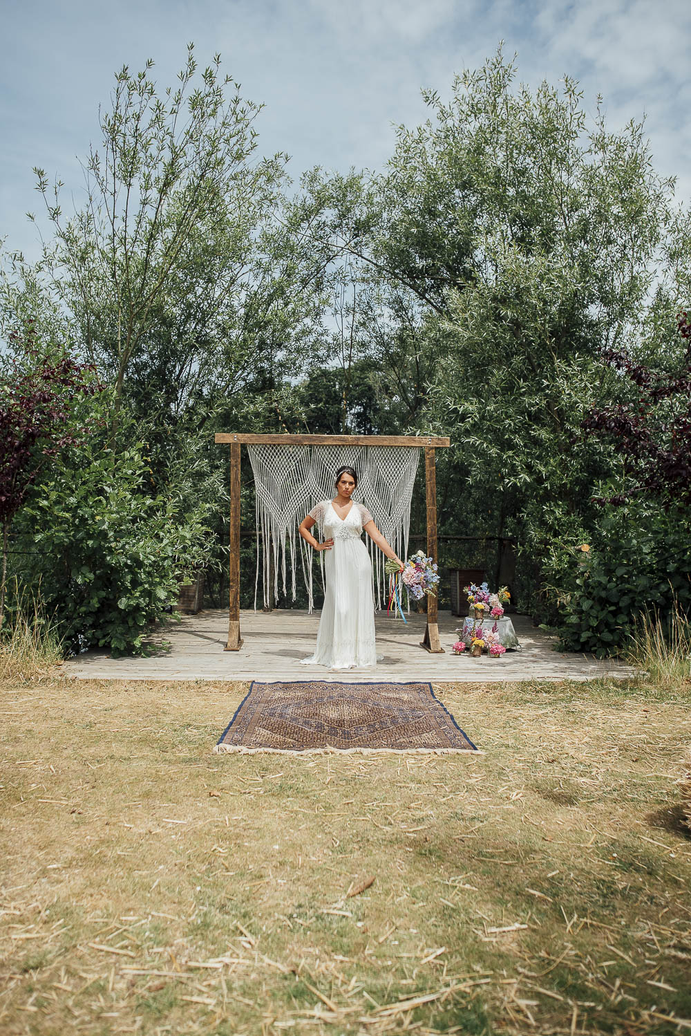 Macrame Wooden Frame Backdrop Ceremony Aisle Persian Rug Ribbons Flowers Colourful Pretty Floral Tipi Boho Wedding Ideas Purple Pear Tree Photography