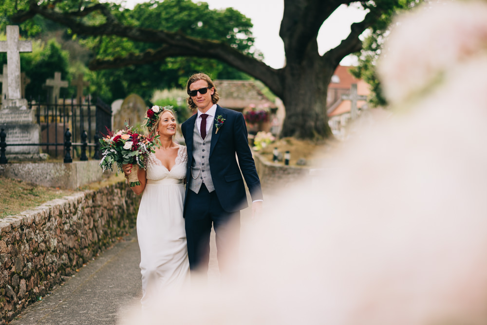 Bride Bridal Laure de Sazagan Dress Lace Cap Sleeve Three Piece Suit Grey Waistcoat Groom Foliage Crown Red Bouquet Jersey Beach Wedding Peakography
