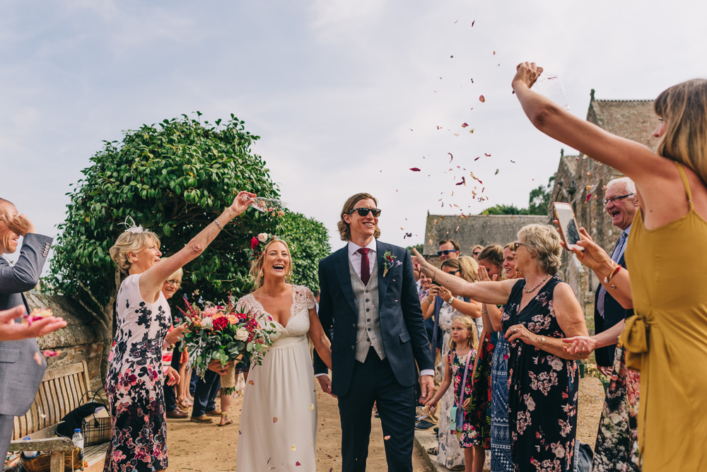 Bride Bridal Laure de Sazagan Dress Lace Cap Sleeve Three Piece Suit Grey Waistcoat Groom Foliage Crown Red Bouquet Confetti Jersey Beach Wedding Peakography