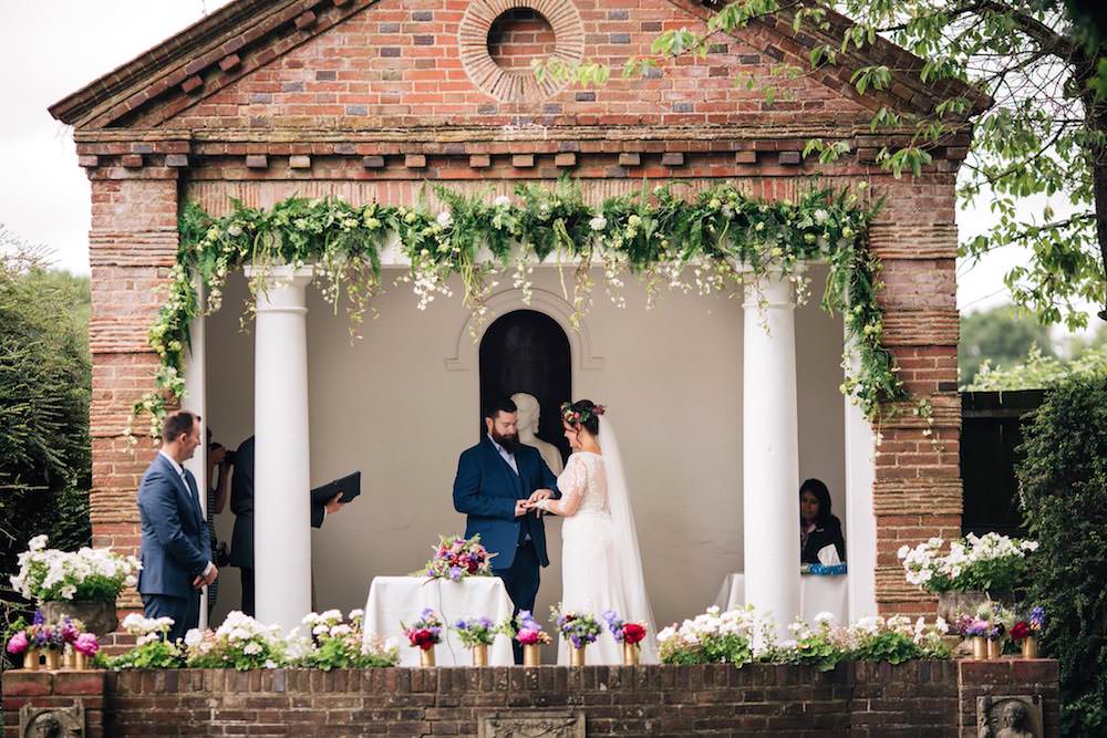 Bride Bridal Dress Gown Lace Sleeves Bodice Train Flower Crown Blue Suit Groom Gold Vase Jewel Tone Pink Blue Micklefield Hall Wedding Red On Blonde Photography