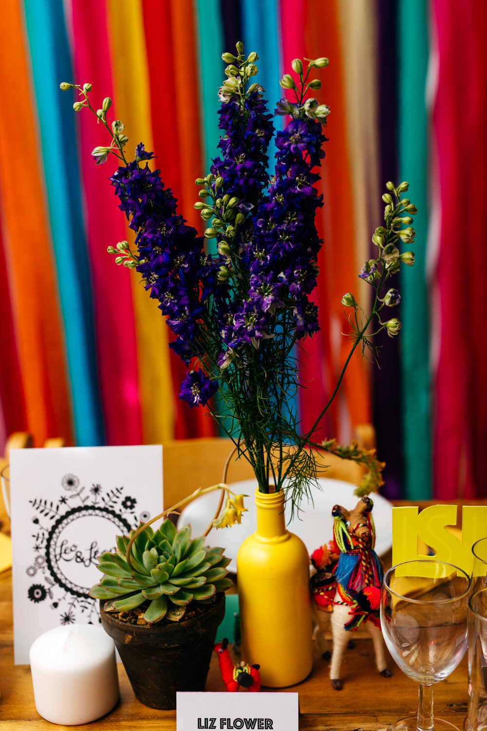 Painted Bottle Flowers Decor Table Centrepiece Rainbow Colourful Ribbon Backdrop Ash Barton Estate Wedding Jordanna Marston Photography