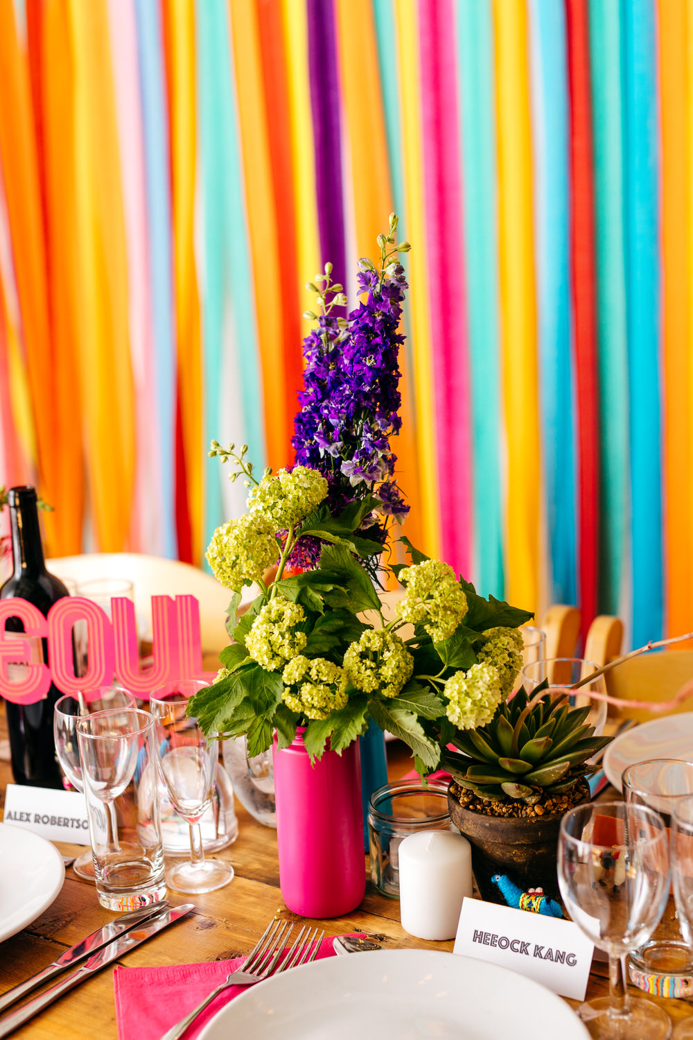 Painted Bottle Flowers Decor Table Centrepiece Rainbow Colourful Ribbon Backdrop Ash Barton Estate Wedding Jordanna Marston Photography