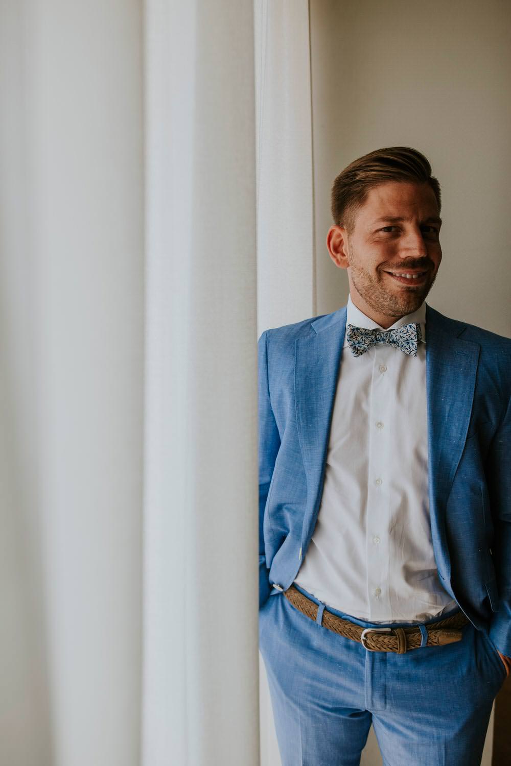 Groom Blue Suit Bow Tie Bohemian Beach Greece Destination Wedding Lighthouse Photography