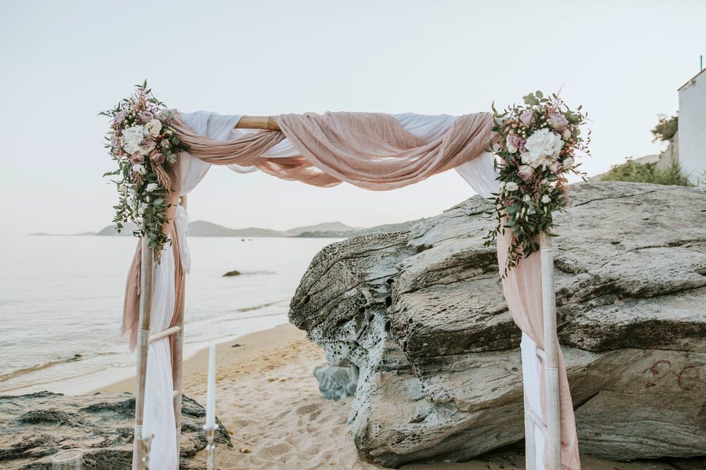 Ceremony Backdrop Aisle Fabric Flowers Arch Bohemian Beach Greece Destination Wedding Lighthouse Photography