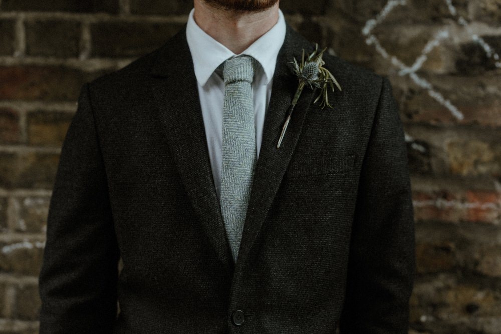 Groom Suit Charcoal Harris Tweed Suit Knitted Tie Thistle Buttonhole Brunel Museum Wedding Olivia and Dan Photography