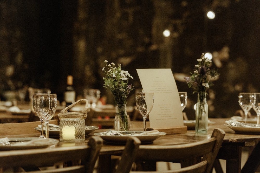 Long Wooden Tables Chairs Flowers Bottles Brunel Museum Wedding Olivia and Dan Photography