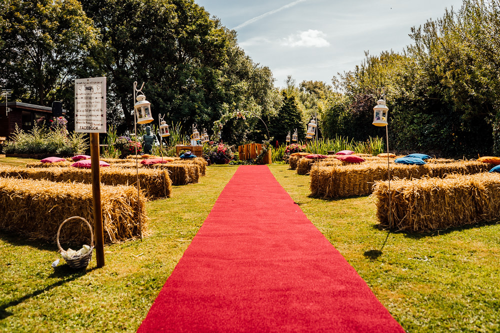 Outdoor Ceremony Red Carpet Hay Bales Shepherds Crook Lanterns Colourful Tipi Garden Wedding Fairclough Studios
