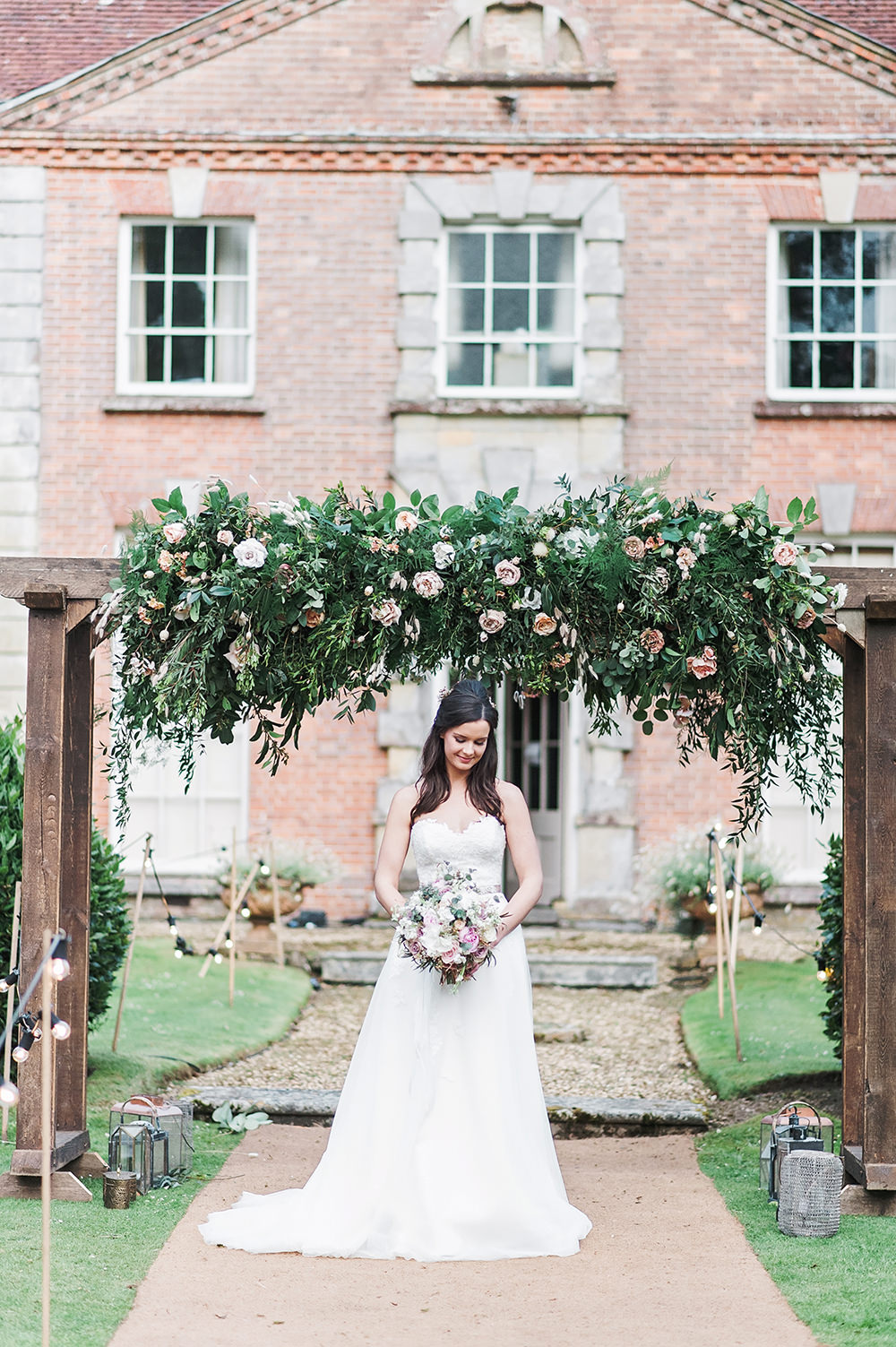Bride Bridal Gown Dress Strapless Sweetheart Neckline Ribbon Belt Pink Greenery Foliage Rose Arch Edmondsham House Wedding Darima Frampton Photography