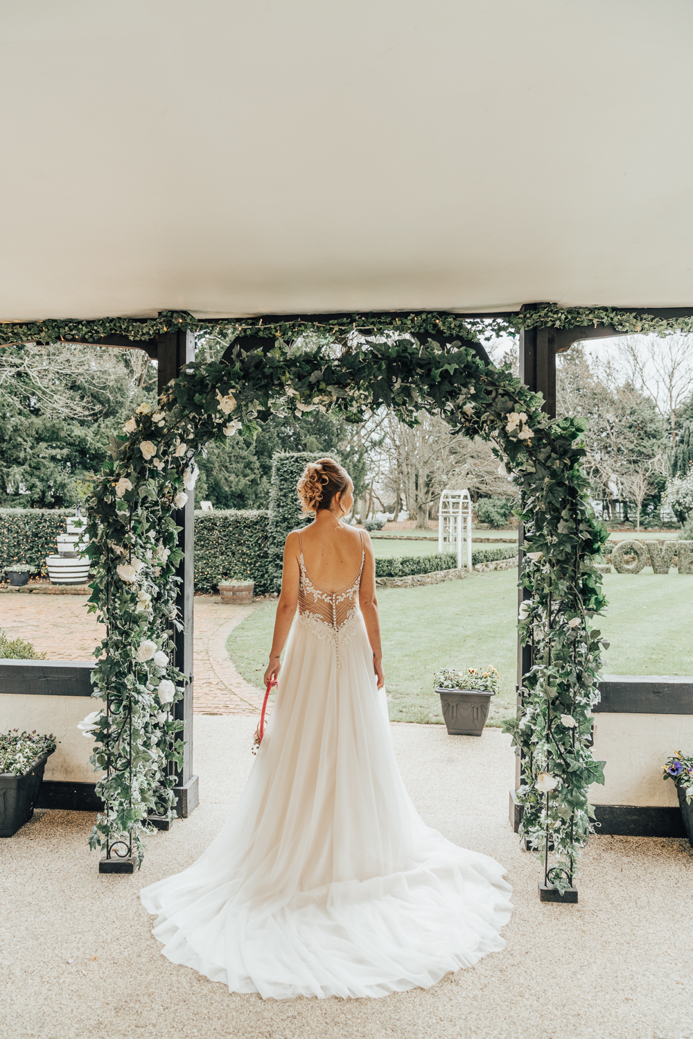 Dress Gown Bride Bridal Train Beaded Lace Back Straps Greenery Foliage Arch Flower Backdrop Hoop Wedding Ideas Rebecca Carpenter Photography