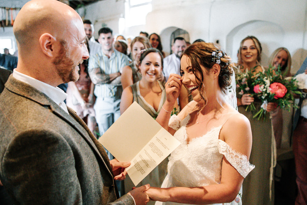 Bride Bridal Dress Gown Lace Detail Drop Cold Shoulder Ribbon Bow Sleeveless Tweed Suit Waistcoat Groom Floral Veil Stanford Farm Wedding Andy Griffiths Photography