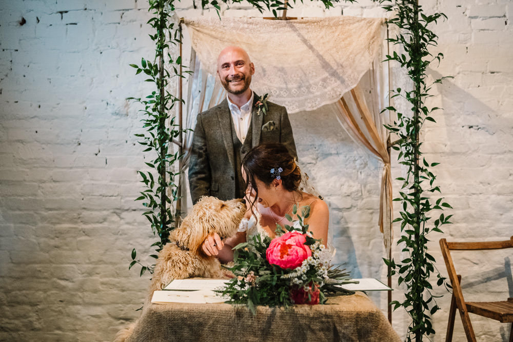 Bride Bridal Dress Gown Lace Detail Drop Cold Shoulder Ribbon Bow Sleeveless Tweed Suit Dog Waistcoat Groom Floral Veil Stanford Farm Wedding Andy Griffiths Photography