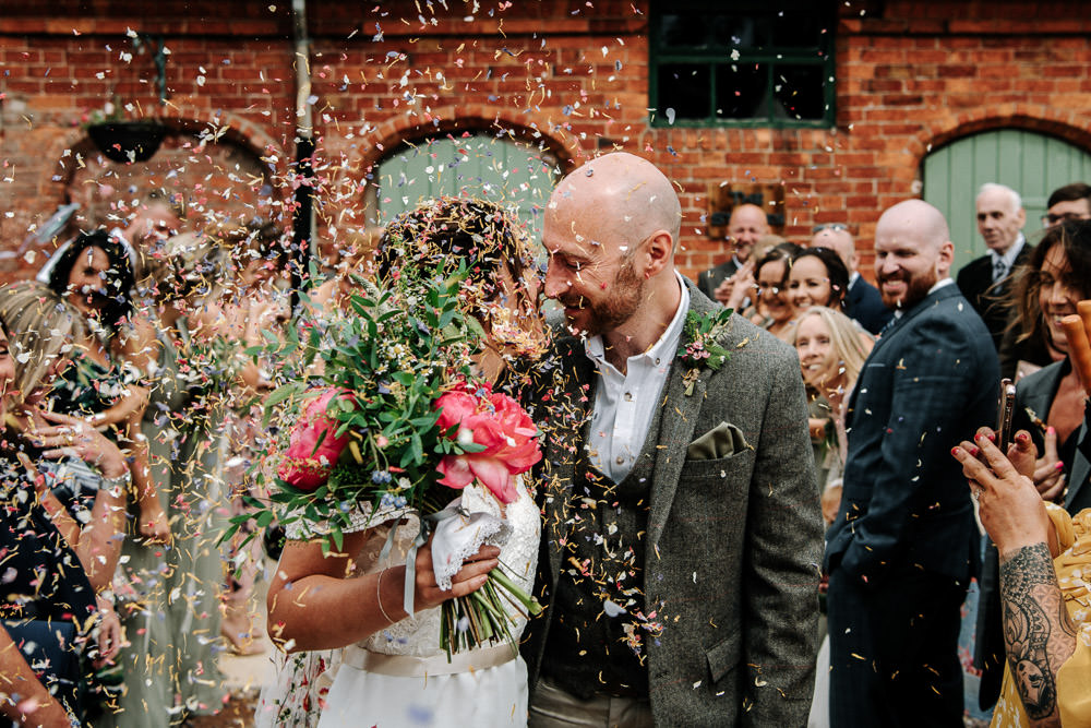 Bride Bridal Dress Gown Lace Detail Drop Cold Shoulder Ribbon Bow Sleeveless Tweed Suit Waistcoat Groom Floral Veil Bouquet Confetti Stanford Farm Wedding Andy Griffiths Photography