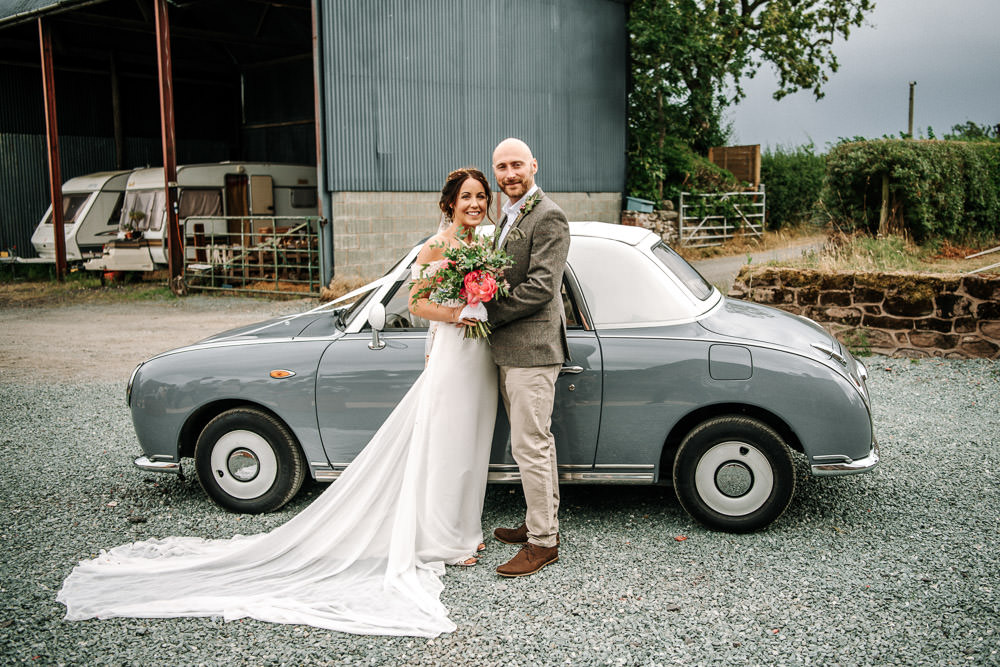 Bride Bridal Dress Gown Lace Detail Drop Cold Shoulder Ribbon Bow Sleeveless Tweed Suit Waistcoat Groom Floral Veil Bouquet Stanford Farm Wedding Andy Griffiths Photography